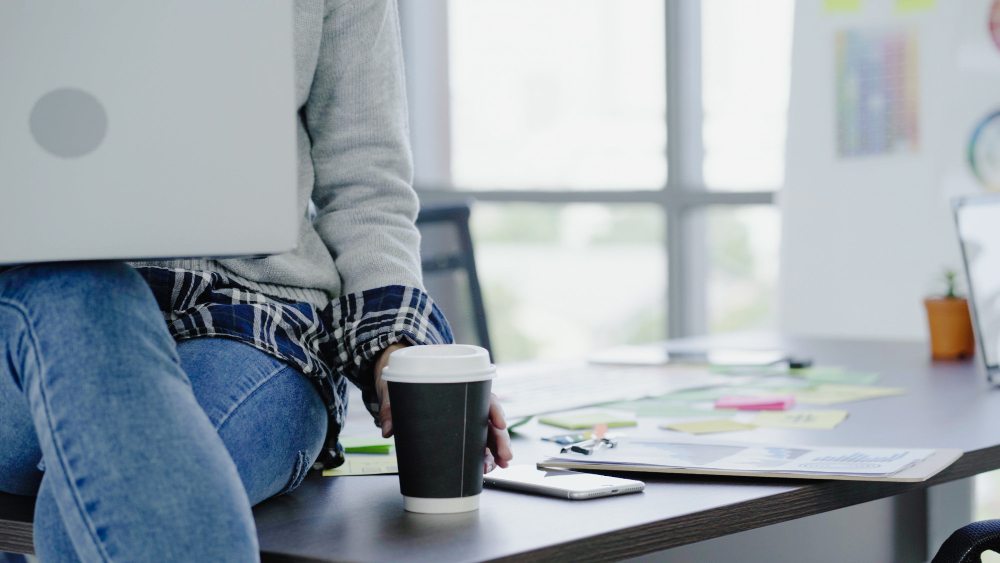 woman in empty office with laptop