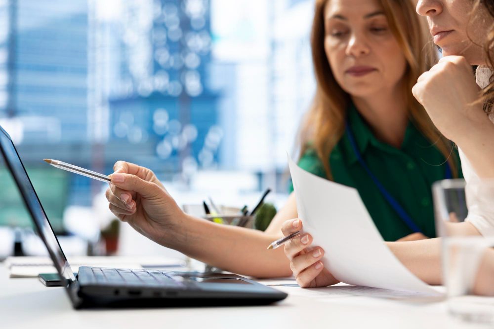 office workers typing on laptop