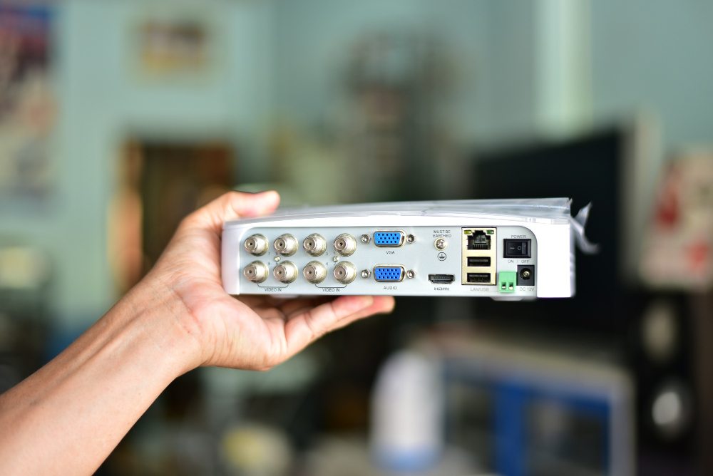 white digital video recorder held in hand