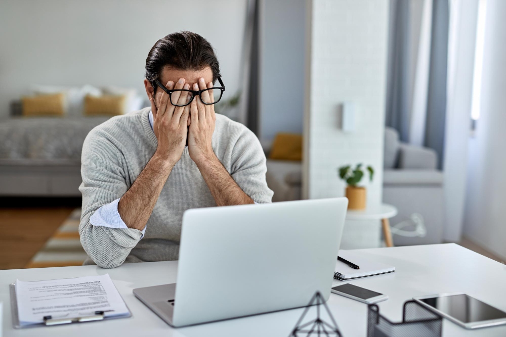 man overwhelmed from too many emails