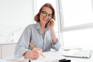 Professional listening to a recorded phone call and taking notes