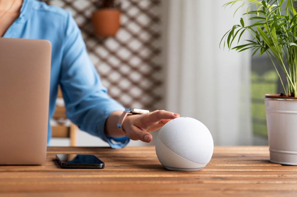 woman using smart speaker connected to amazon alexa