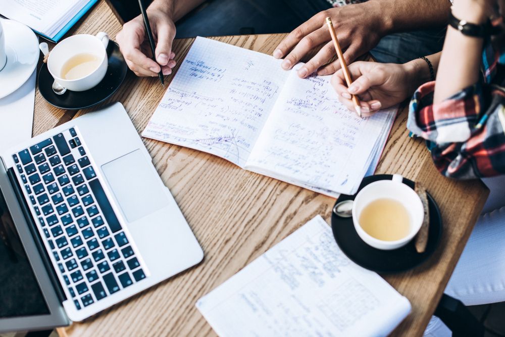 manager reviewing meeting summary on laptop