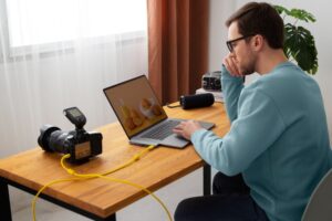 editor removing text from video on laptop