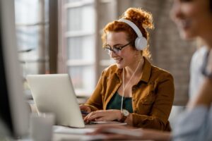 user uploading a video file into an ai tool on a laptop to convert video to text in office setting