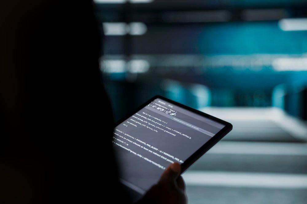 man holding tablet using chatgpt to write code