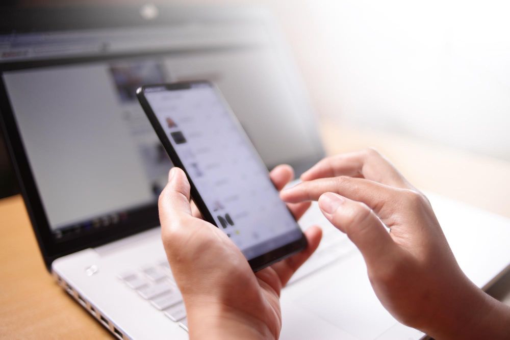 man holding iphone and editing a recording
