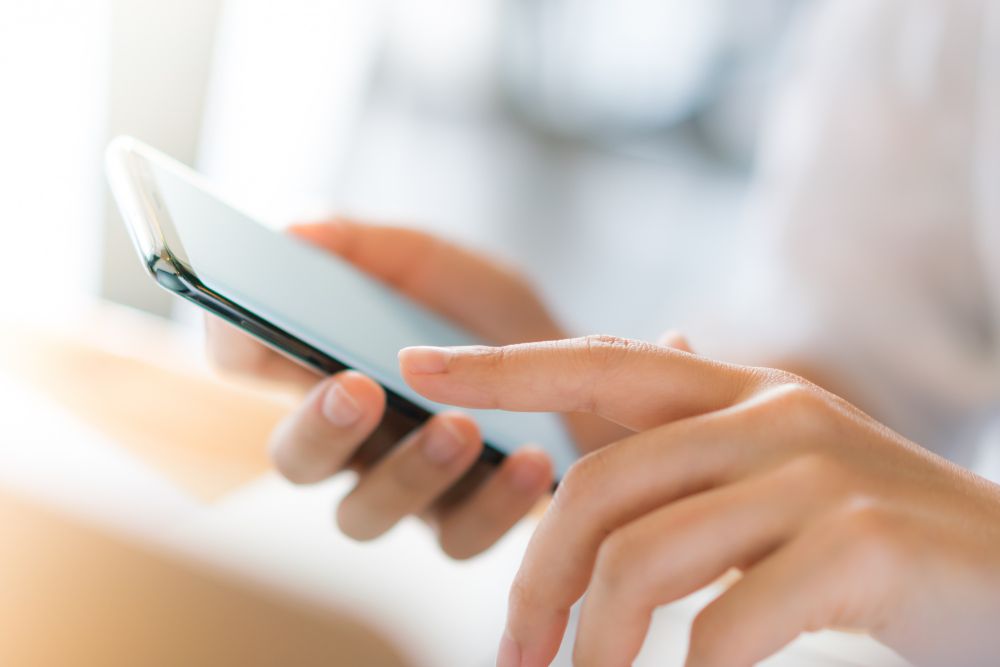 person on iphone using grok